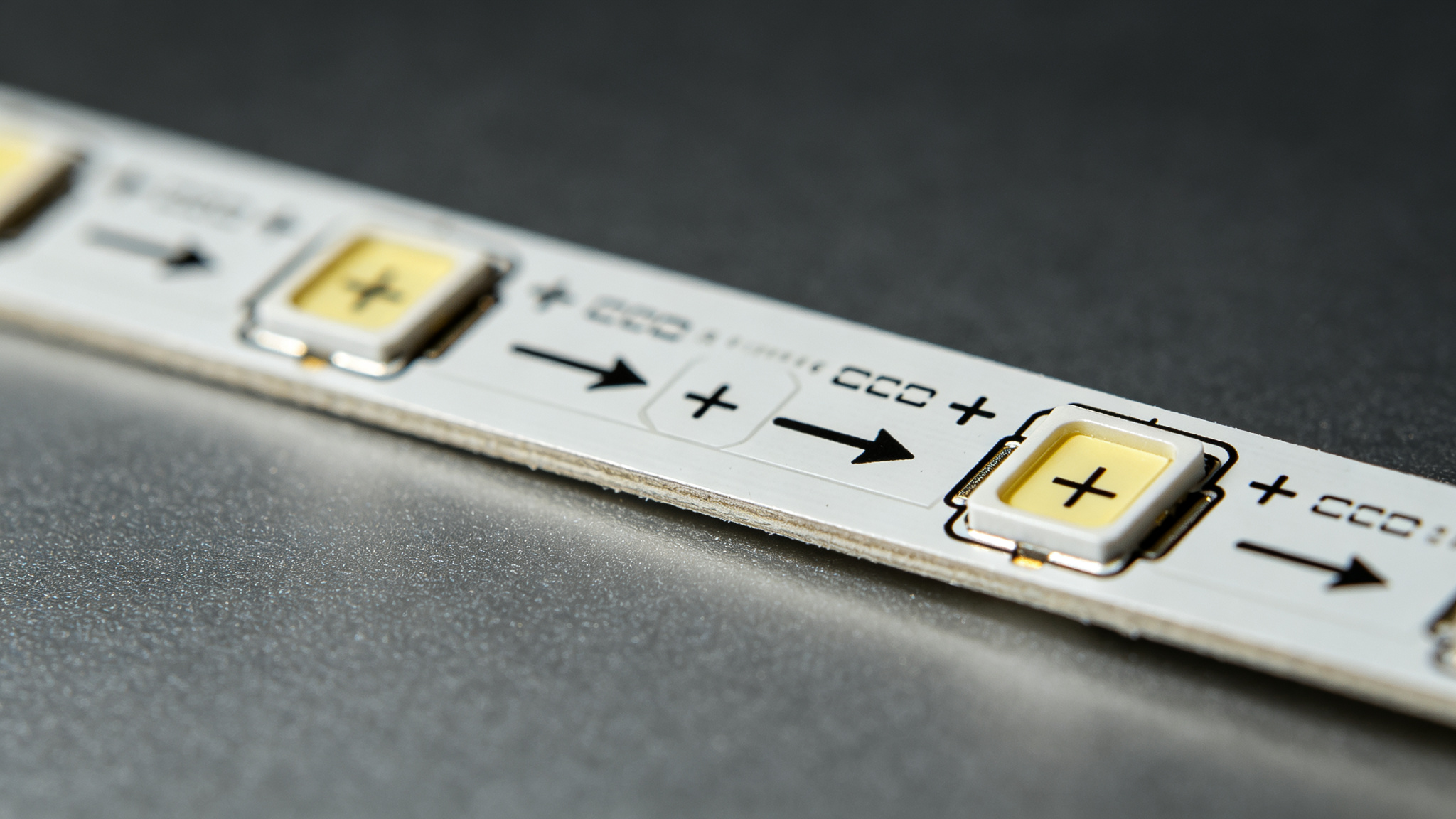 LED strip PCB with printed arrows and plus minus markings